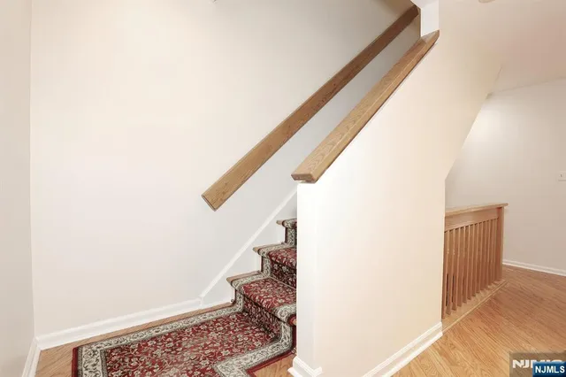 a view of staircase with white walls and a window