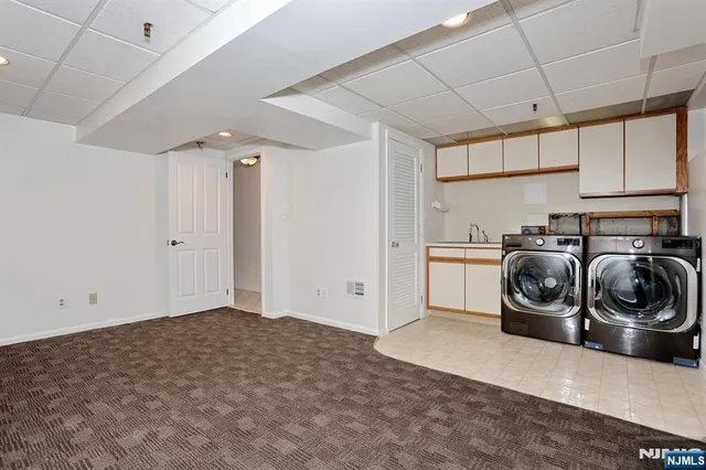 a utility room with sink dryer and washer