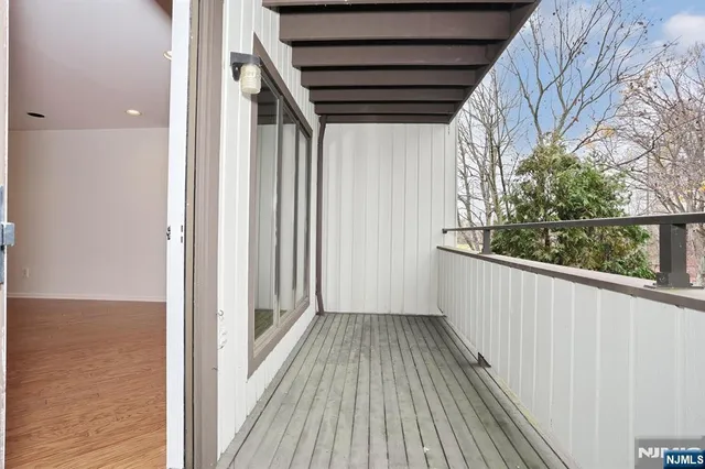a view of a balcony with wooden floor and staircase