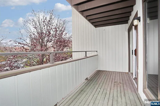a view of a balcony with wooden floor