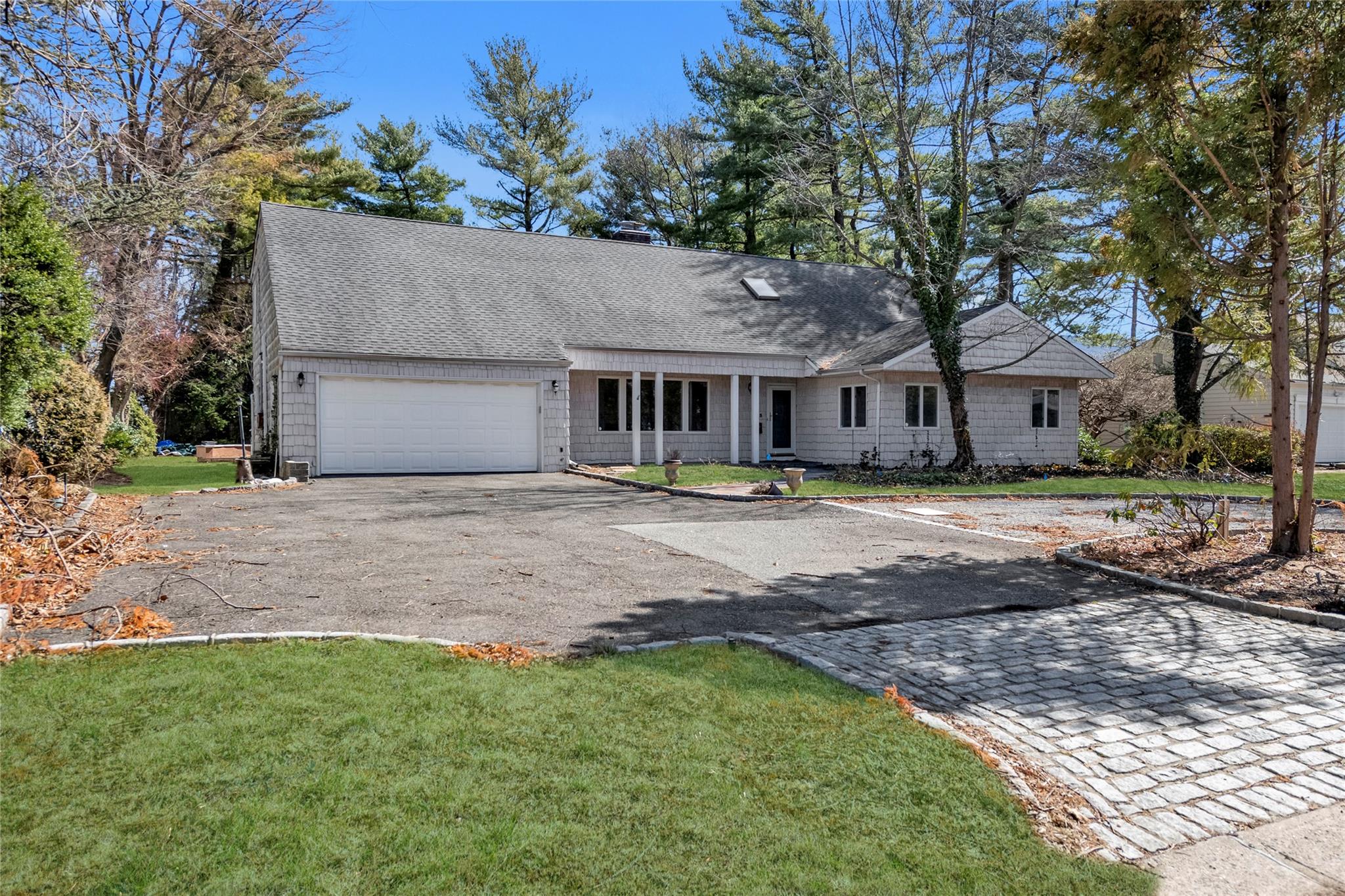 183 Crabapple Road Manhasset, NY 11030 - Photo 1 of 1 a front view of a house with a yard and trees