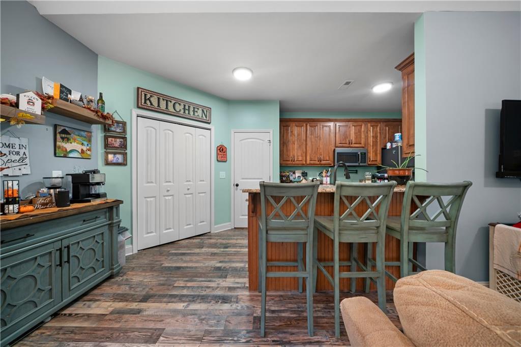 50 Round Rock Circle Northeast Rome, GA 30161 - Photo 11 of 24 a kitchen with stainless steel appliances granite countertop a table chairs sink and cabinets