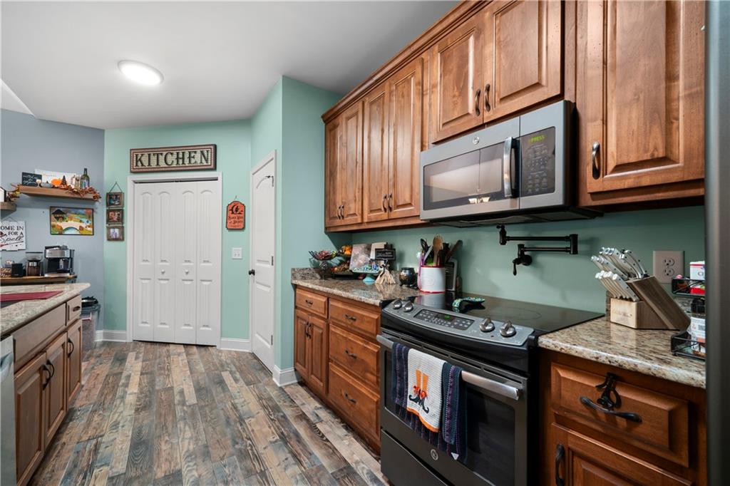 50 Round Rock Circle Northeast Rome, GA 30161 - Photo 14 of 24 a kitchen with stainless steel appliances granite countertop a stove and a refrigerator