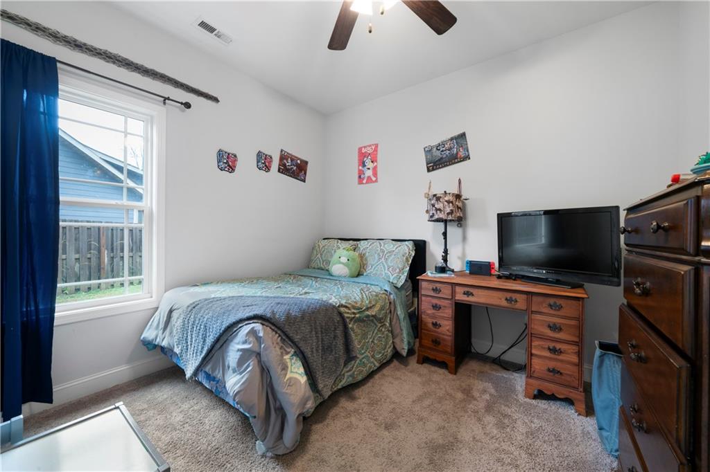 50 Round Rock Circle Northeast Rome, GA 30161 - Photo 20 of 24 a bedroom with a bed and a flat screen tv