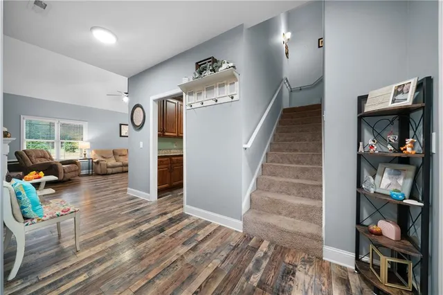 a view of a hallway view with wooden floor and staircase