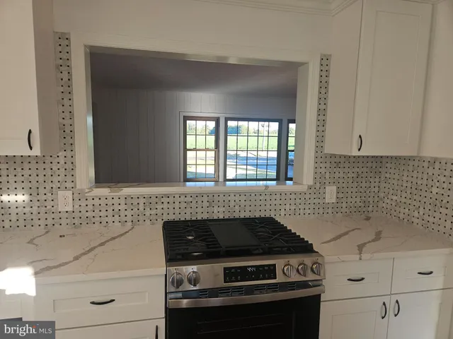 a stove top oven sitting inside of a kitchen