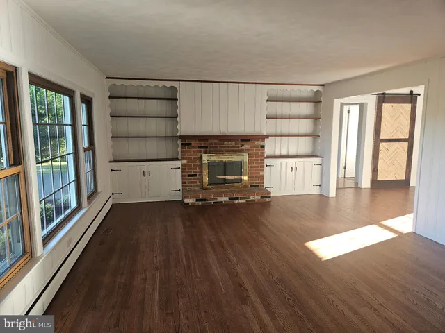 wooden floor in an empty room with a fireplace