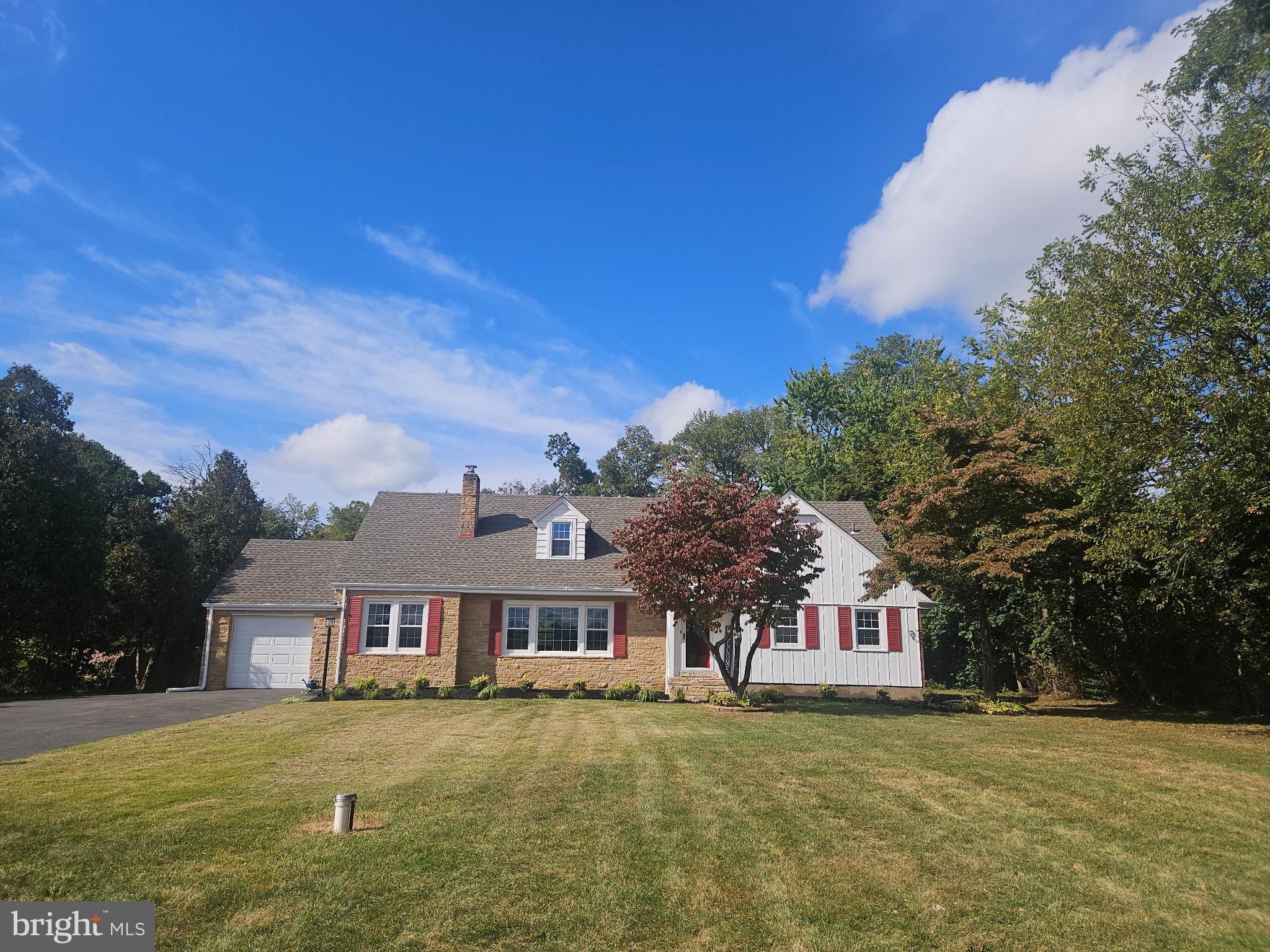 296 Extonville Road Allentown, NJ 08501 - Photo 2 of 46 Charming home with lush greenery and blue skies.