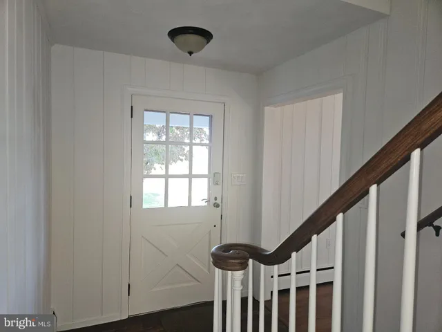 a view of entryway with wooden floor