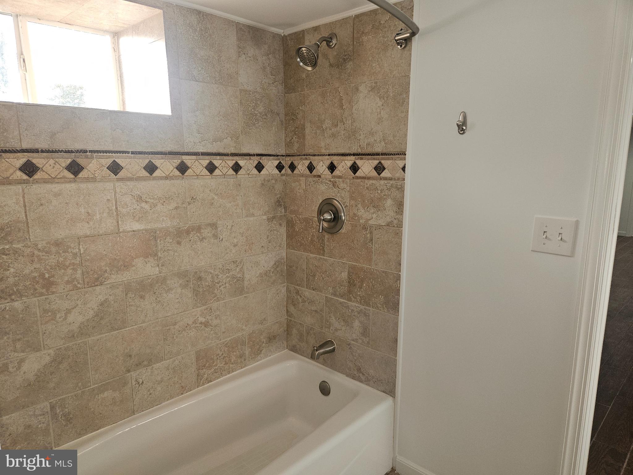 296 Extonville Road Allentown, NJ 08501 - Photo 40 of 46 Elegant tiled shower with natural light.