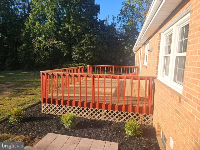 an aerial view of a house with swimming pool and large trees