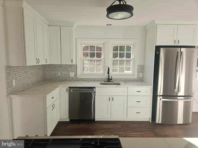 a kitchen with granite countertop a cabinets and a stainless steel appliances