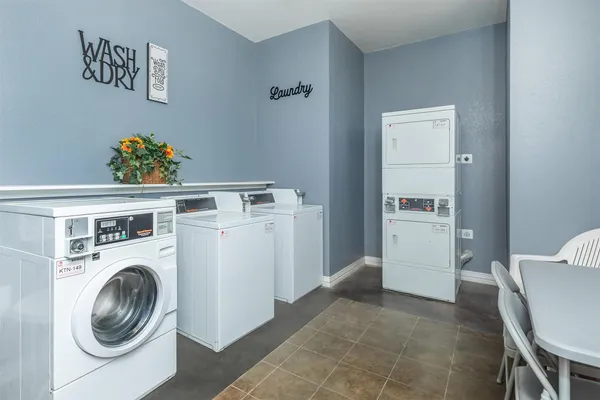 a utility room with dryer washer and a view of kitchen
