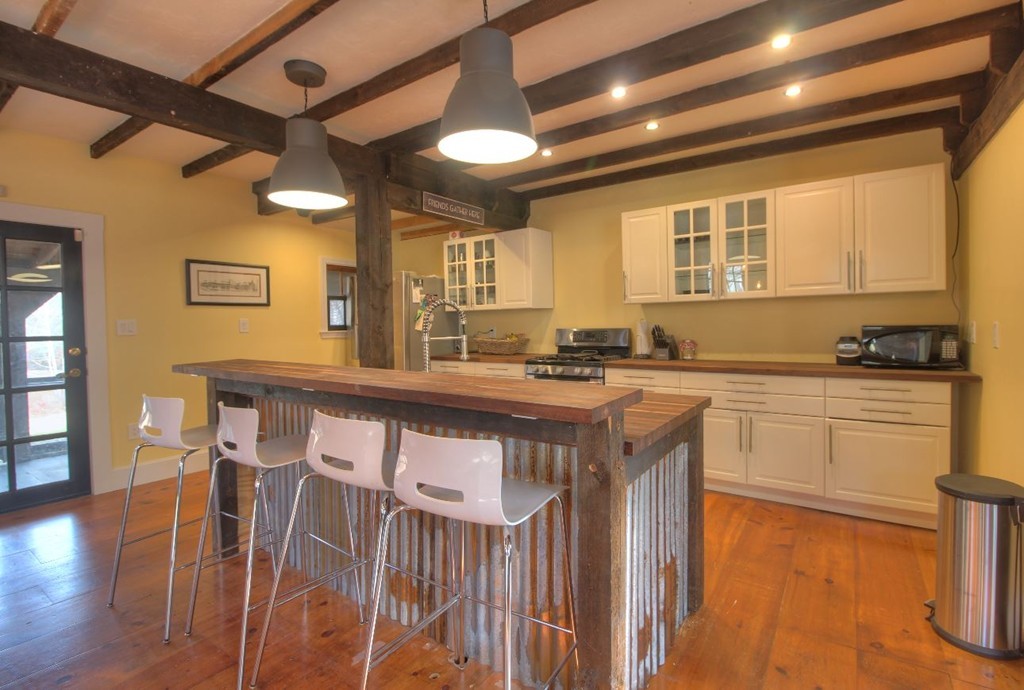 157 Fitchburg Road Townsend, MA 01469 - Photo 2 of 17 a kitchen with stainless steel appliances granite countertop a stove a sink dishwasher and cabinets with wooden floor