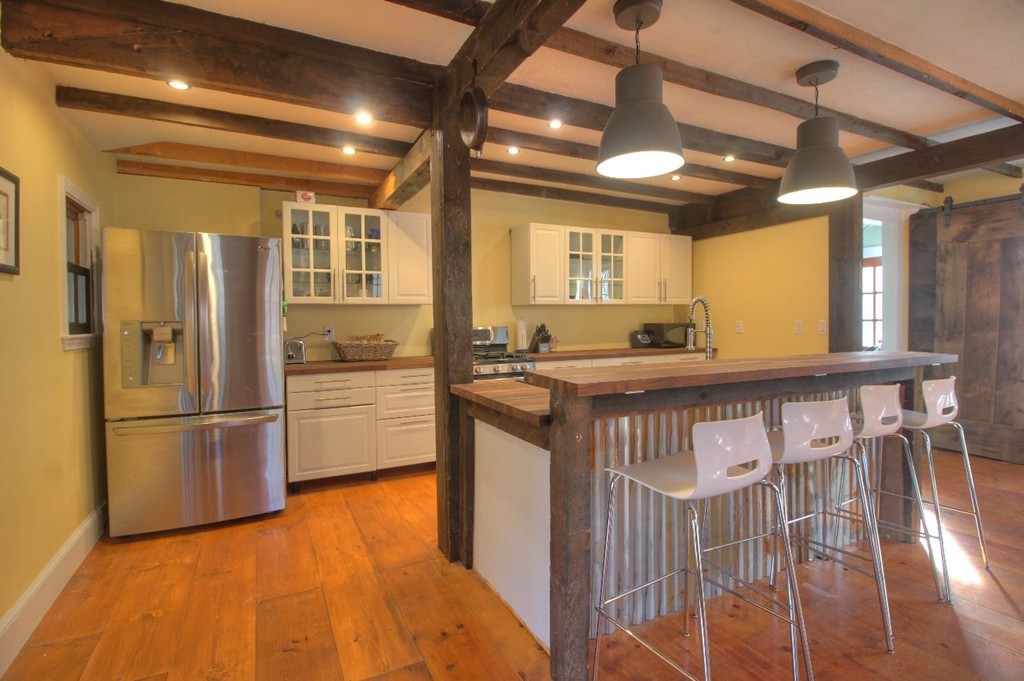 157 Fitchburg Road Townsend, MA 01469 - Photo 3 of 17 a kitchen with stainless steel appliances granite countertop a refrigerator a stove and a wooden floors