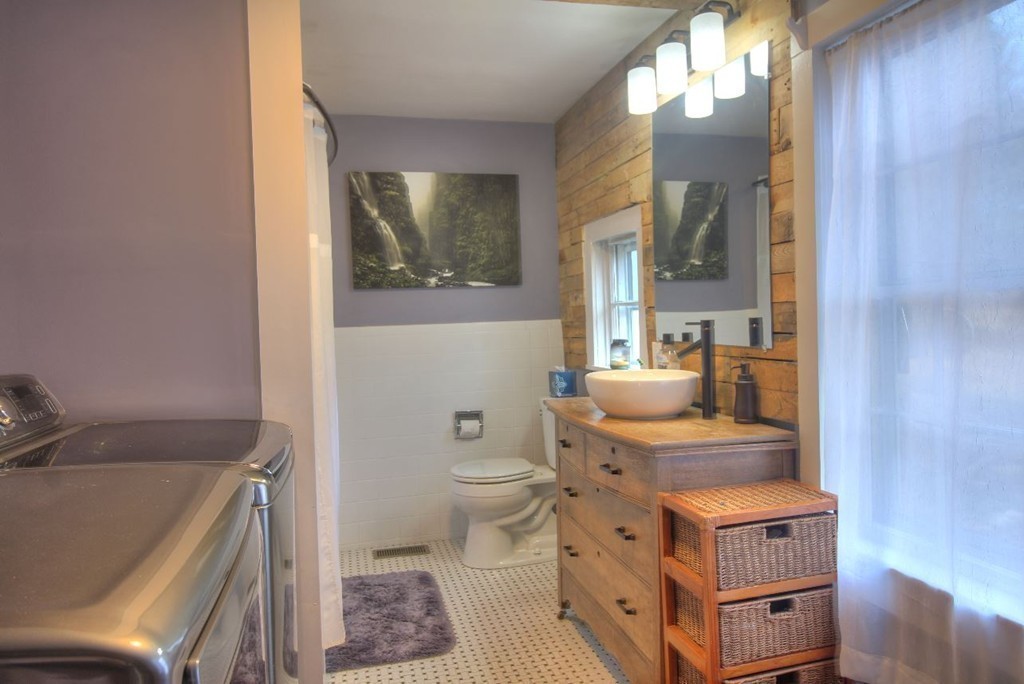 157 Fitchburg Road Townsend, MA 01469 - Photo 10 of 17 a bathroom with a sink a toilet and mirror