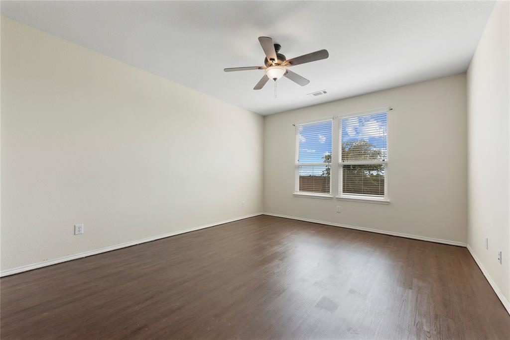 2239 Heaton Street Forney, TX 75126 - Photo 14 of 25 a view of an empty room with wooden floor and a window