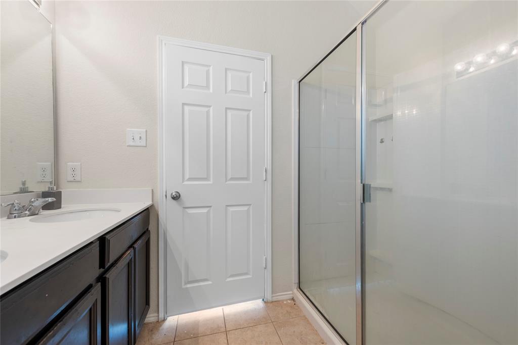 2239 Heaton Street Forney, TX 75126 - Photo 17 of 25 a bathroom with a sink and a mirror