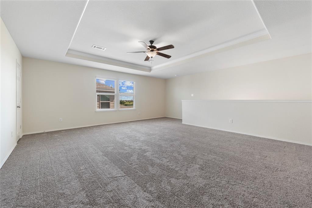 2239 Heaton Street Forney, TX 75126 - Photo 19 of 25 an empty room with chandelier fan and windows