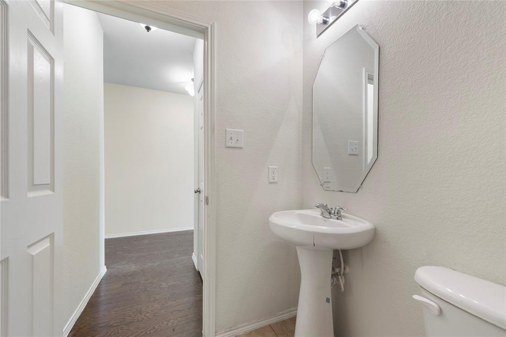 2239 Heaton Street Forney, TX 75126 - Photo 4 of 25 a bathroom with a sink a mirror and toilet