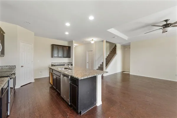 a kitchen with a stove and a wooden floors