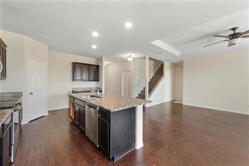 2239 Heaton Street Forney, TX 75126 - Photo 9 of 25 a kitchen with a stove and a wooden floors