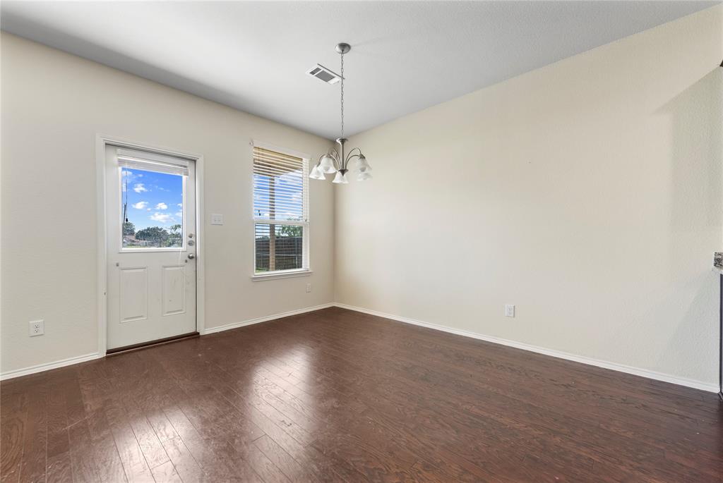 2239 Heaton Street Forney, TX 75126 - Photo 10 of 25 a view of a room with wooden floor a ceiling fan and windows