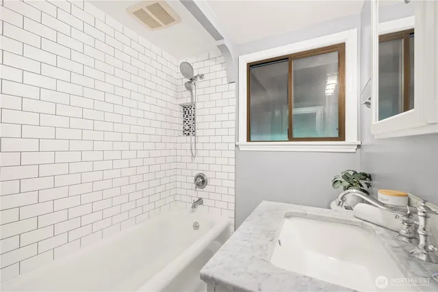 a bathroom with a tub sink and shower
