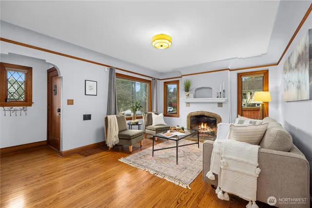 a living room with furniture a fireplace and a wooden floor
