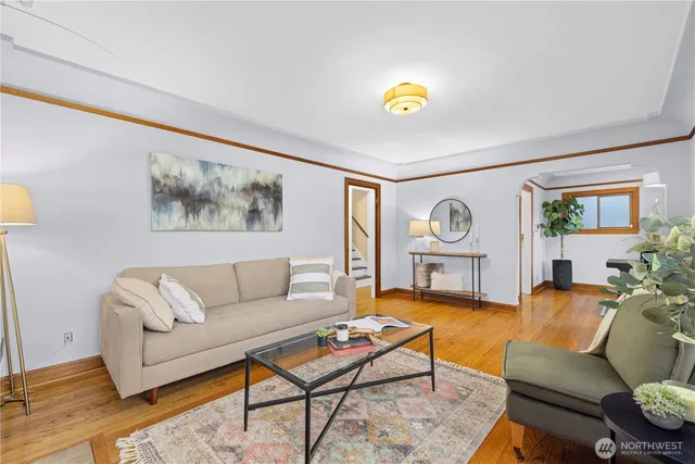 a living room with furniture and a wooden floor