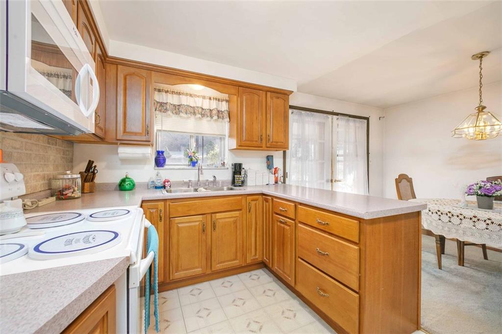 5581 Edwards Road Murrysville, PA 15668 - Photo 17 of 25 Enjoy cooking in the U Shaped kitchen with breakfast bar.