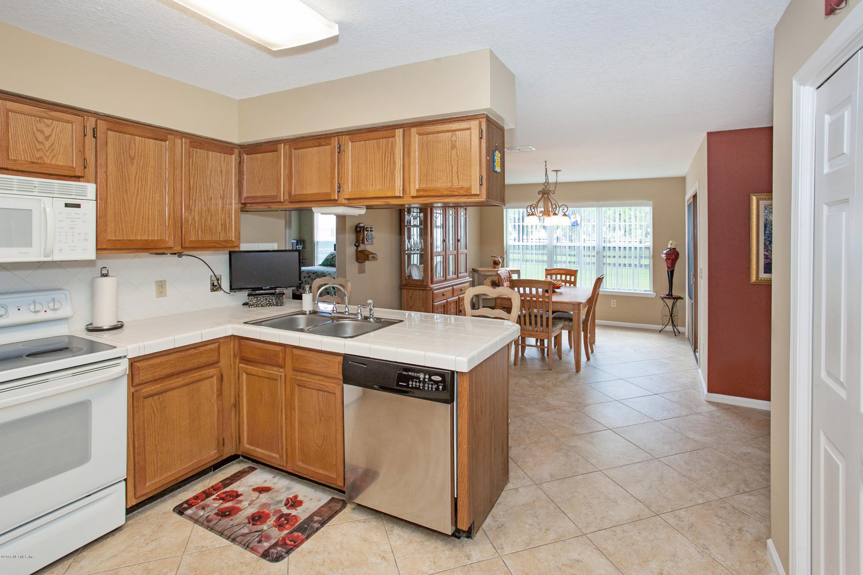 4735 Wolfe Road St. Augustine, FL 32092 - Photo 13 of 39 a kitchen with a cabinets a counter top space and stainless steel appliances