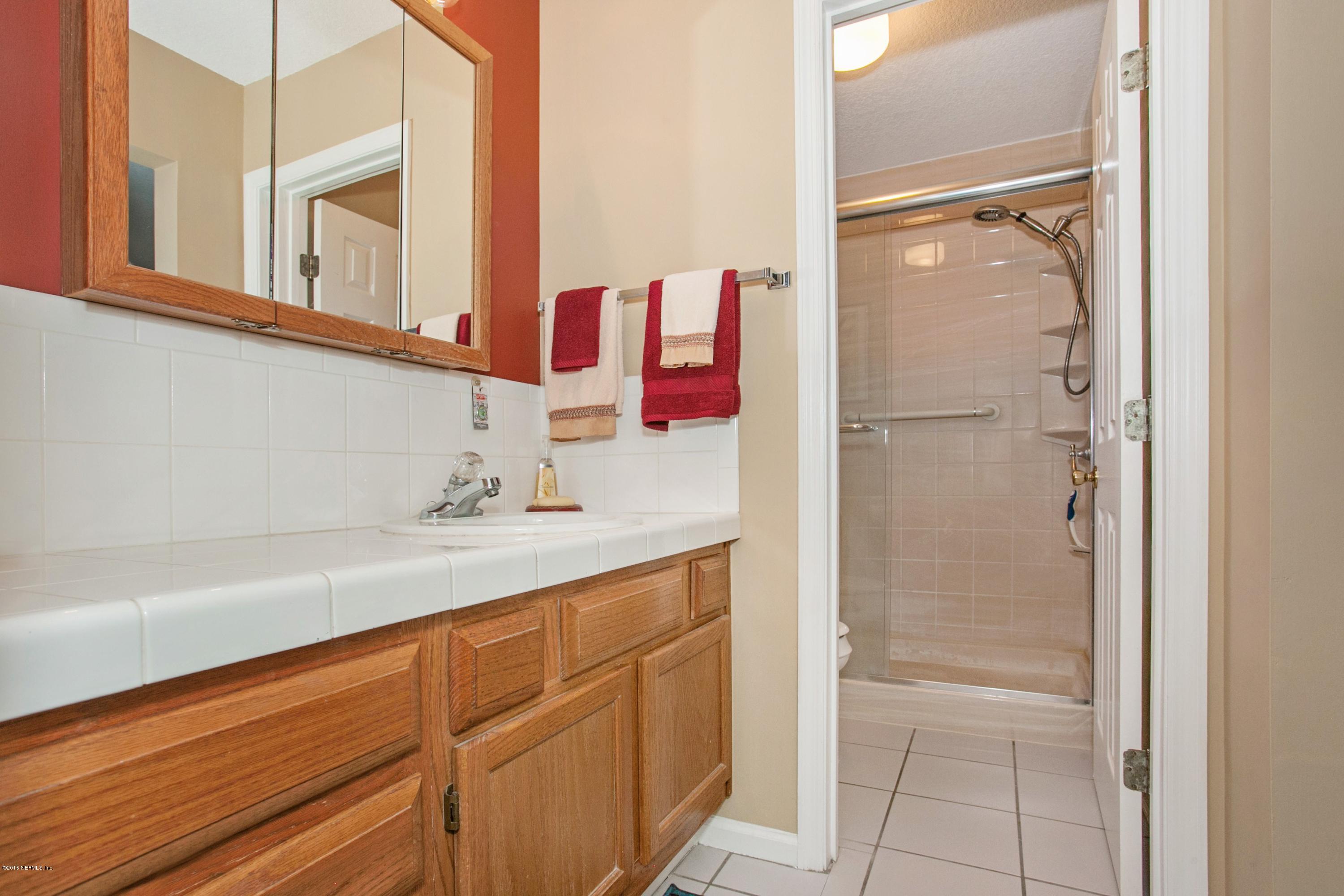 4735 Wolfe Road St. Augustine, FL 32092 - Photo 17 of 39 a bathroom with a sink and a mirror