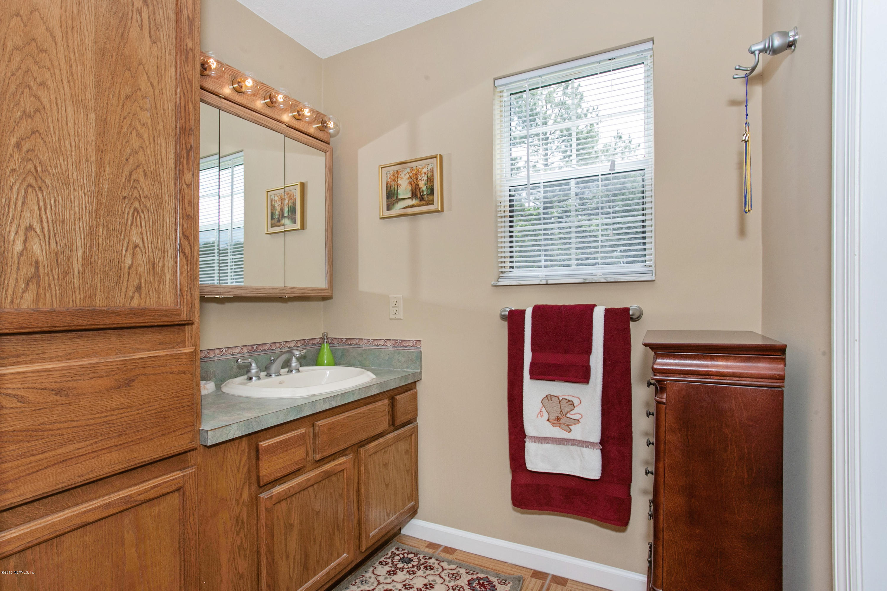 4735 Wolfe Road St. Augustine, FL 32092 - Photo 20 of 39 a bathroom with a sink and a mirror