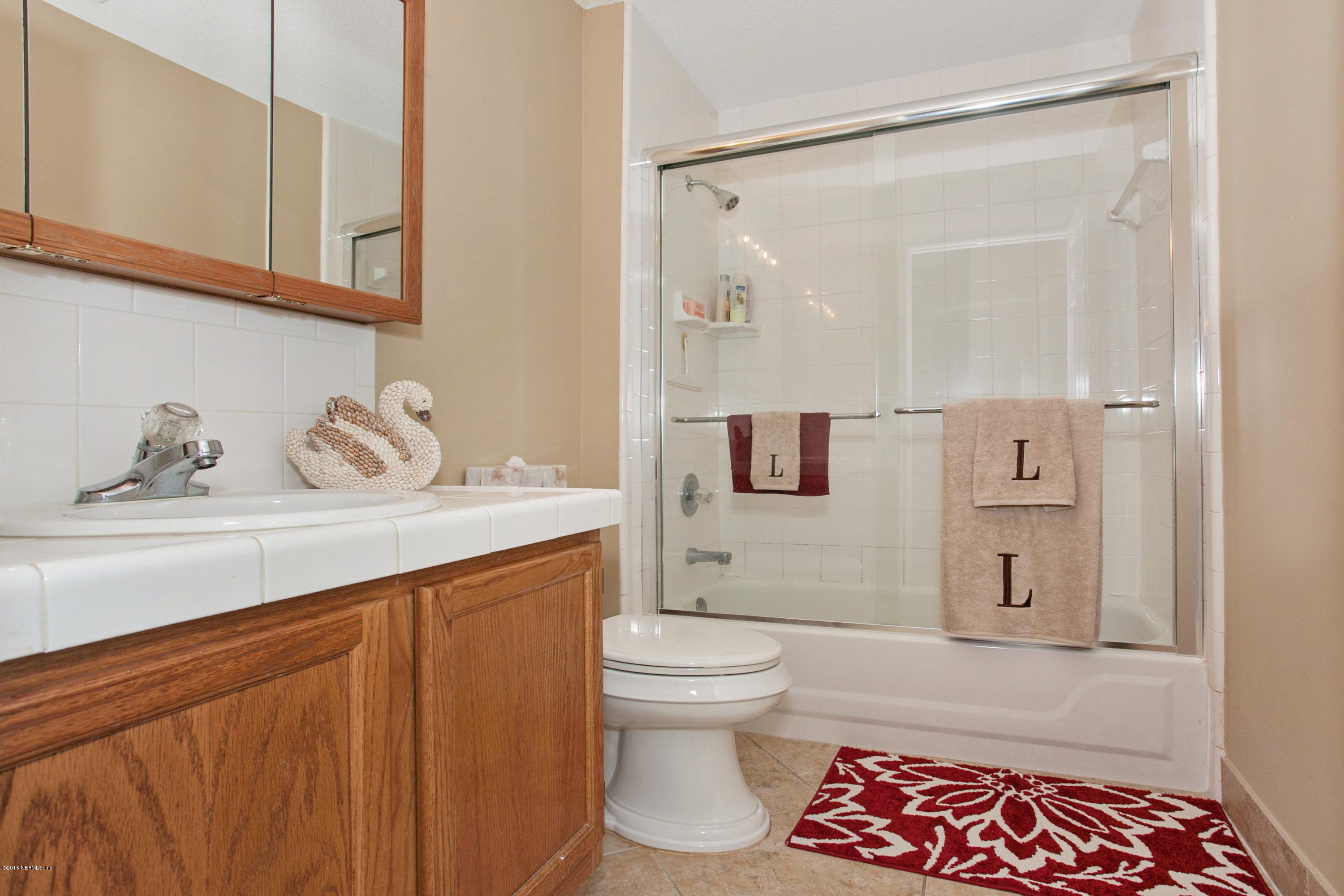 4735 Wolfe Road St. Augustine, FL 32092 - Photo 22 of 39 a bathroom with a sink a toilet and shower