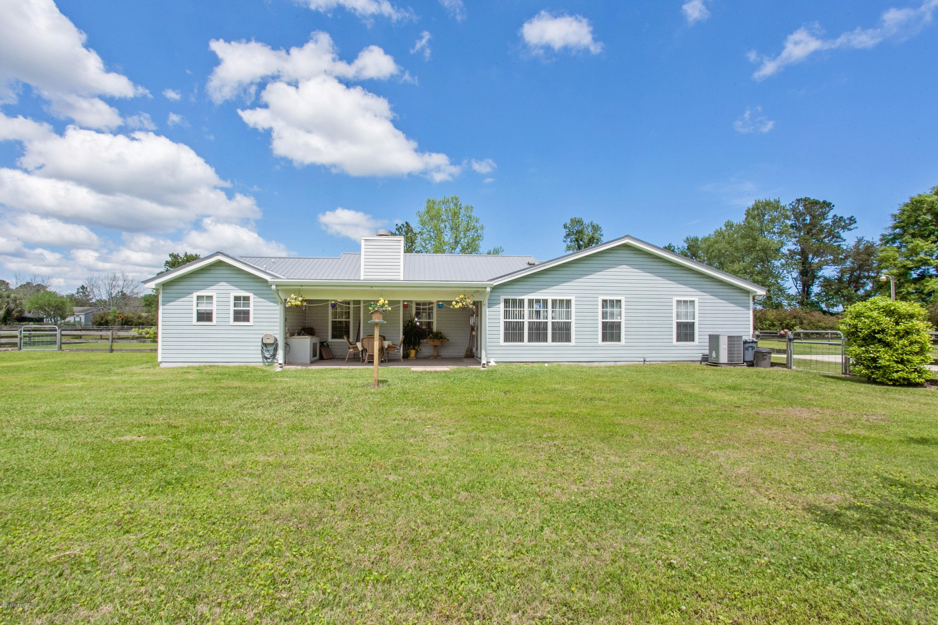 4735 Wolfe Road St. Augustine, FL 32092 - Photo 26 of 39 a view of a big house with a big yard and large trees