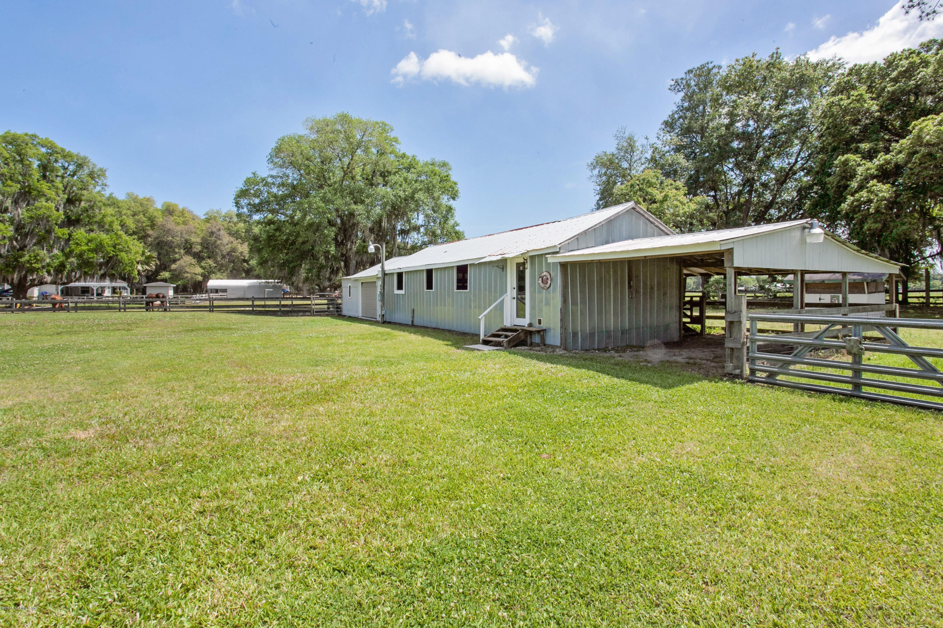 4735 Wolfe Road St. Augustine, FL 32092 - Photo 29 of 39 a view of a house with a yard and sitting area
