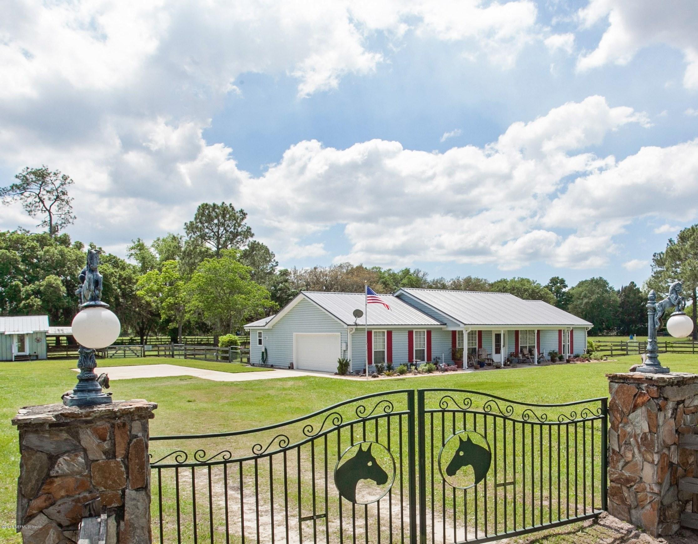 4735 Wolfe Road St. Augustine, FL 32092 - Photo 3 of 39 a front view of a house with garden and porch