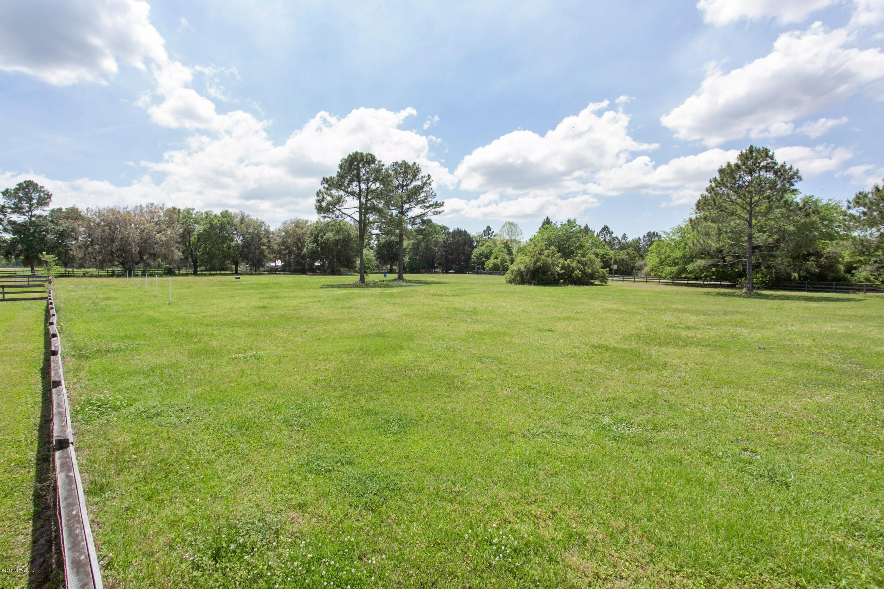 4735 Wolfe Road St. Augustine, FL 32092 - Photo 37 of 39 a view of a field with an trees in the background