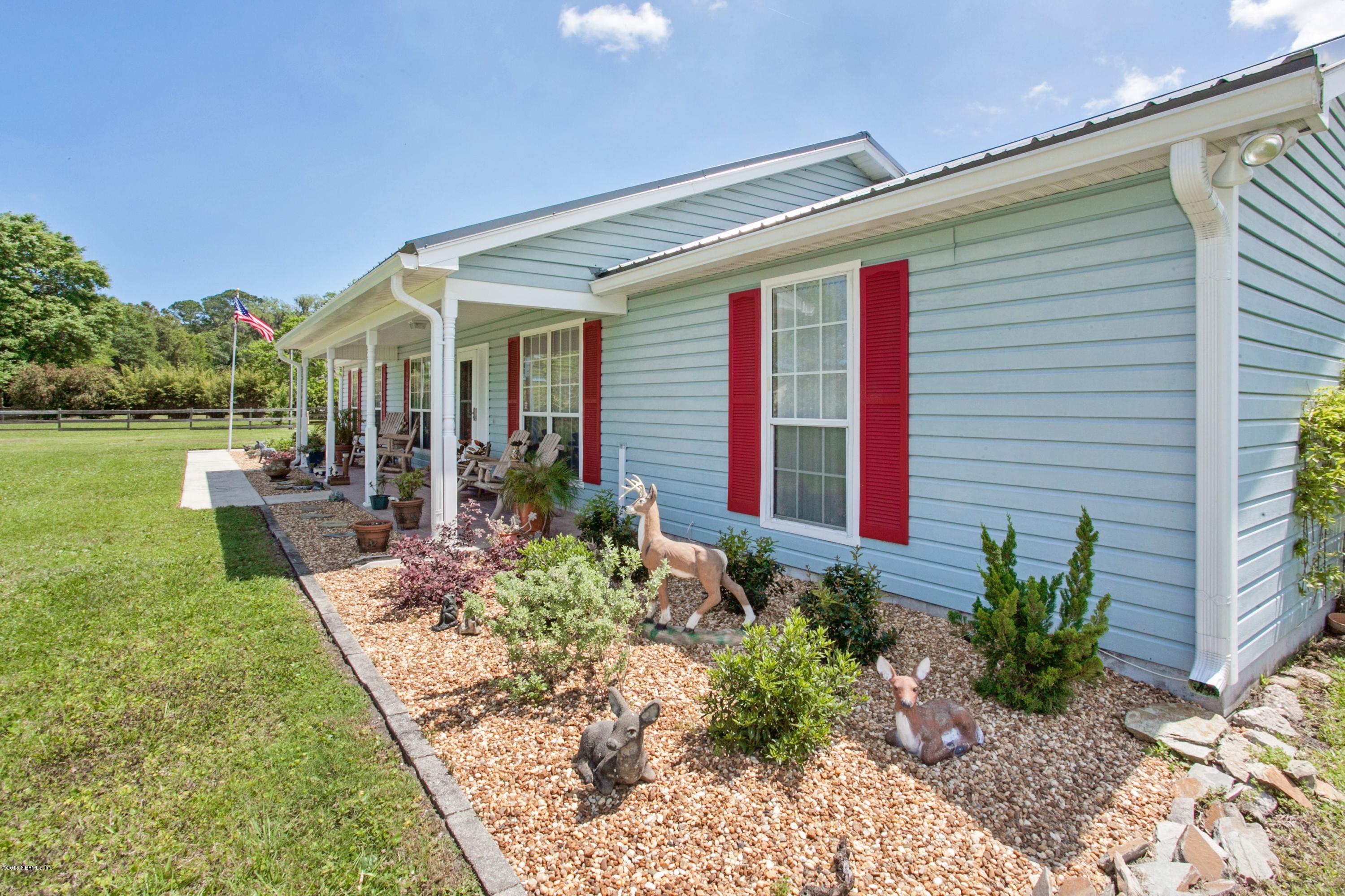 4735 Wolfe Road St. Augustine, FL 32092 - Photo 5 of 39 a front view of a house with garden
