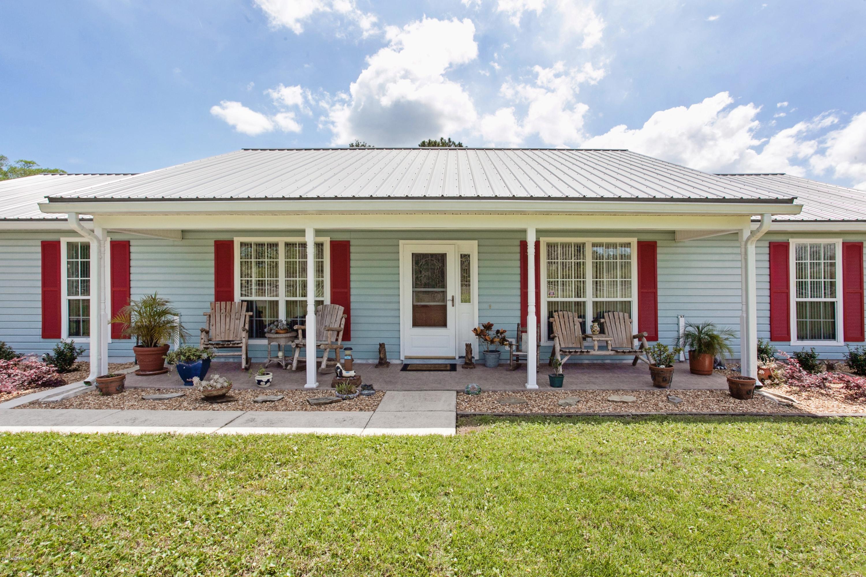 4735 Wolfe Road St. Augustine, FL 32092 - Photo 6 of 39 a group of people sitting in front of a house