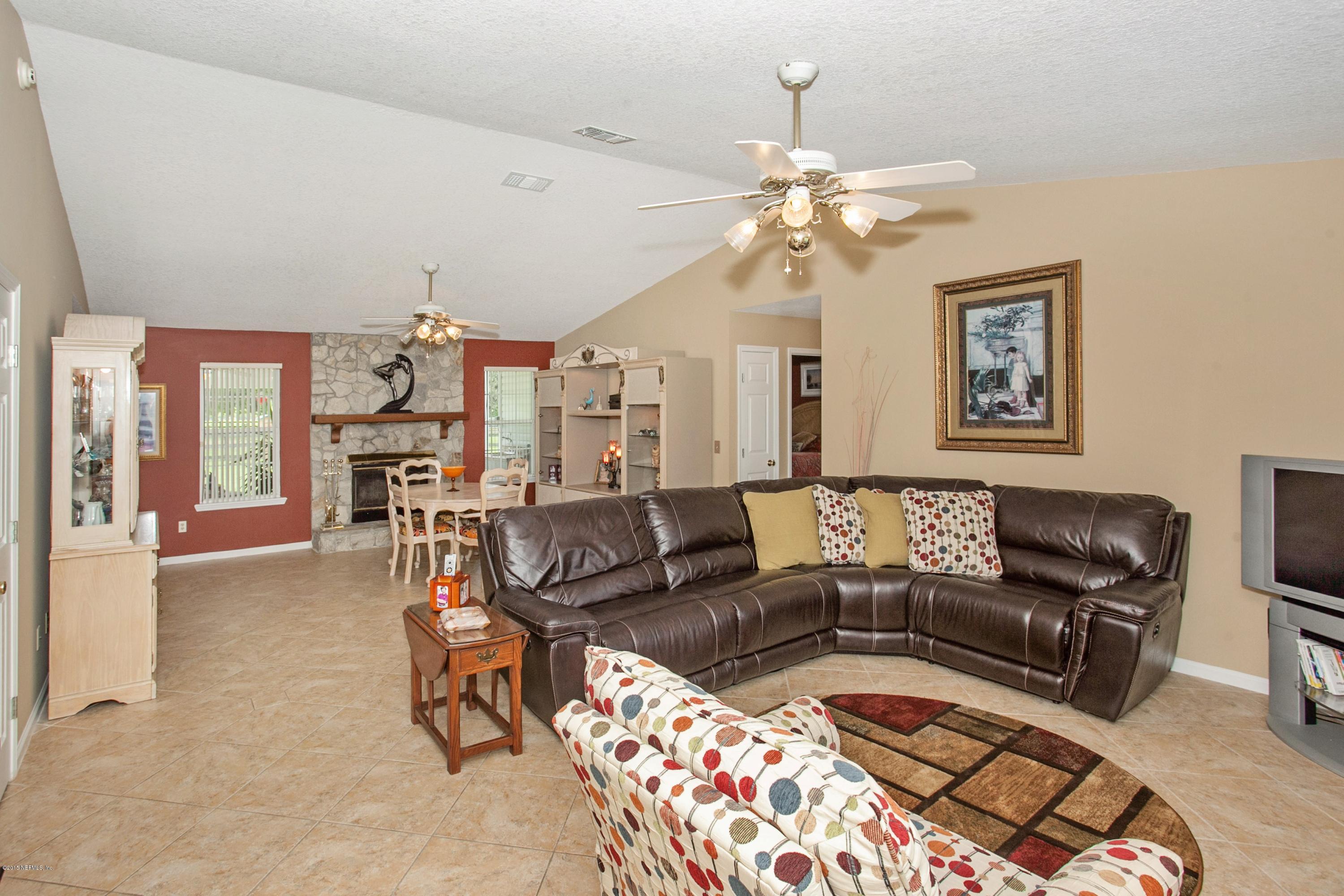 4735 Wolfe Road St. Augustine, FL 32092 - Photo 9 of 39 a living room with furniture and a chandelier