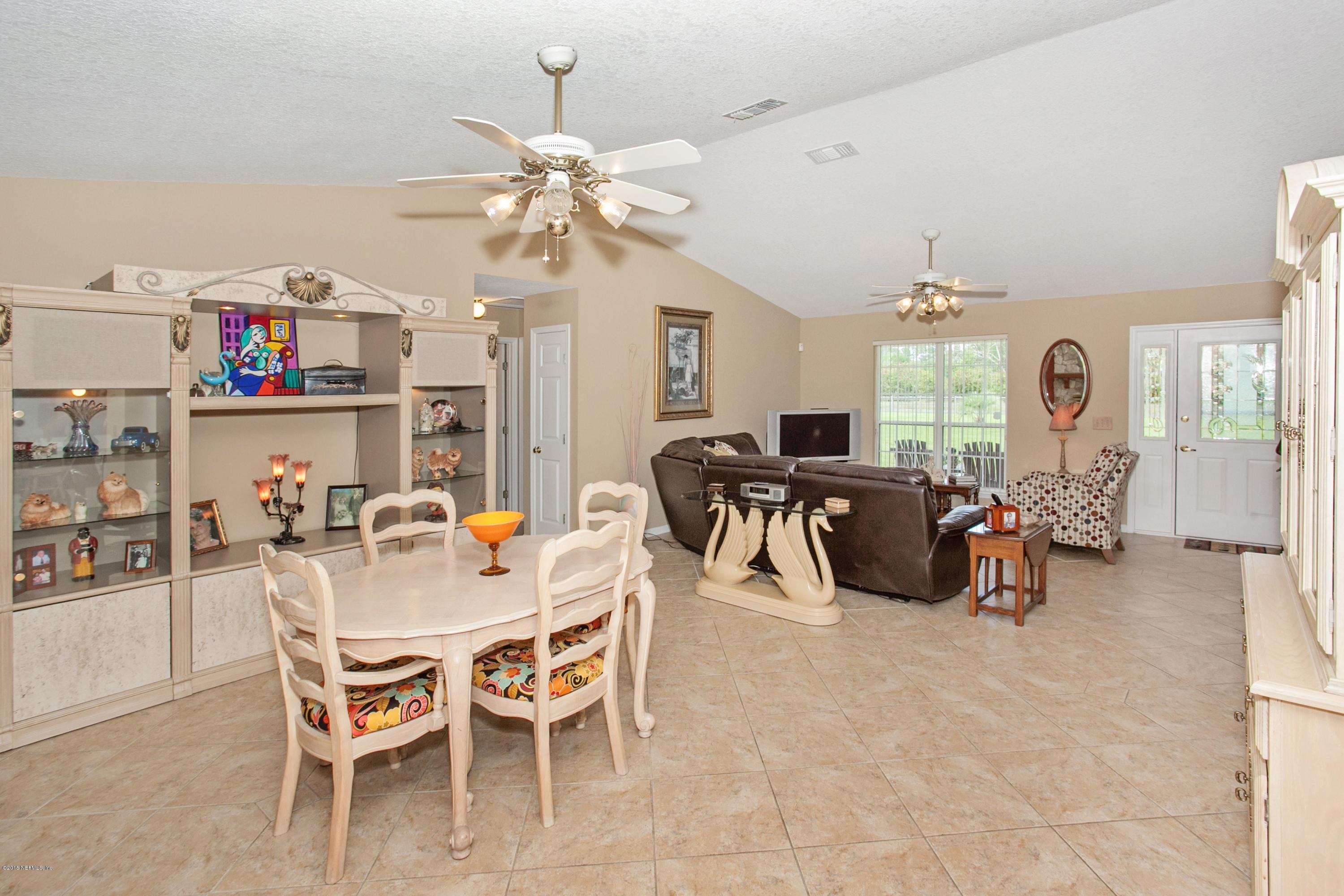 4735 Wolfe Road St. Augustine, FL 32092 - Photo 10 of 39 a view of a dining room and livingroom with furniture a chandelier fan and a rug