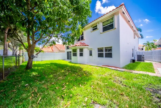 a view of a house with a yard and sitting area