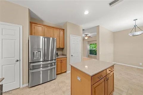 a kitchen with cabinets and stainless steel appliances