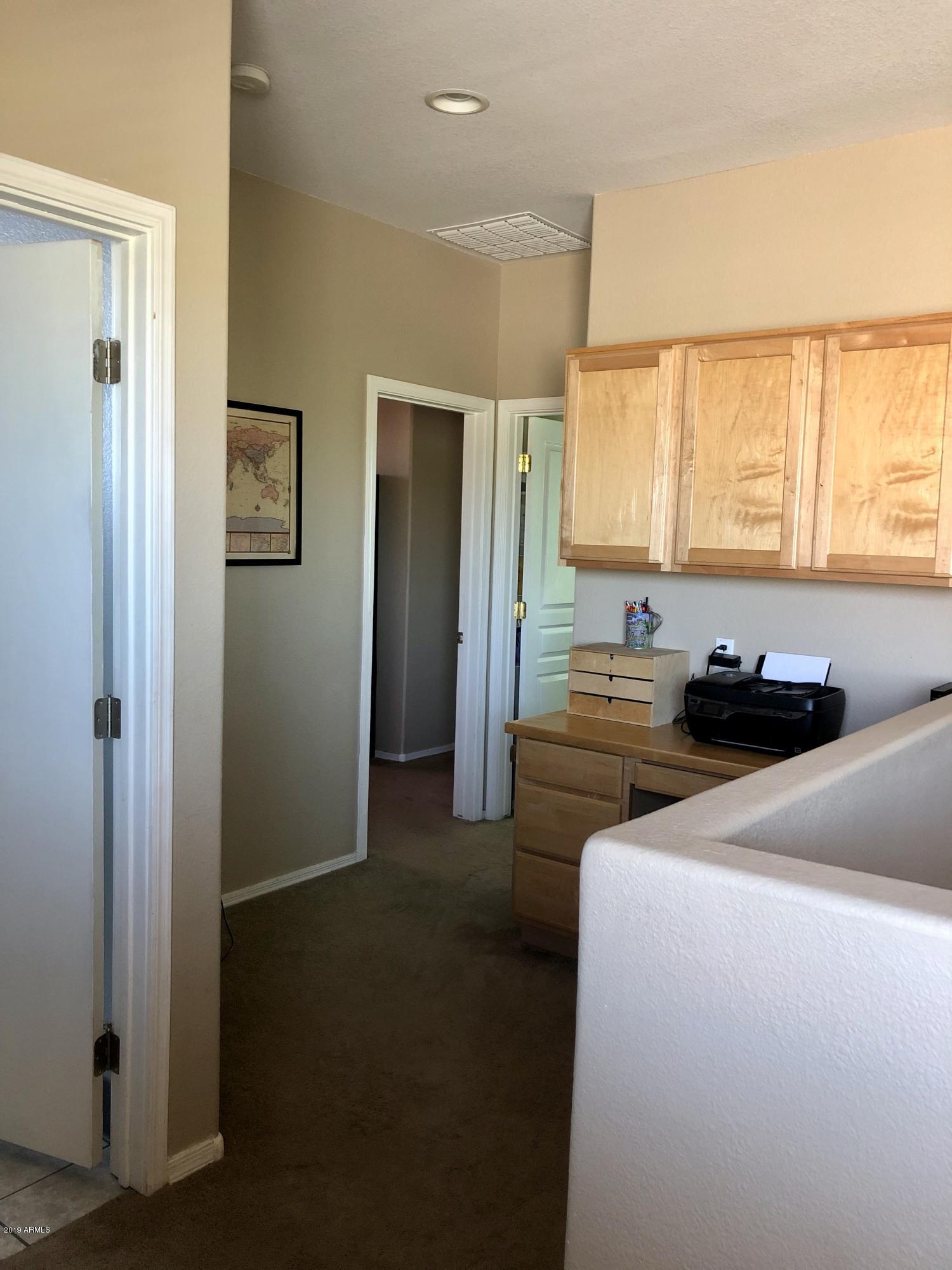 9328 West Berkeley Road Phoenix, AZ 85037 - Photo 4 of 13 a bedroom with a bed and a window