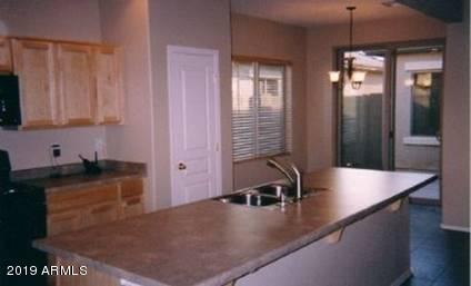 9328 West Berkeley Road Phoenix, AZ 85037 - Photo 5 of 13 a kitchen with stainless steel appliances granite countertop a sink a stove and a granite counter top