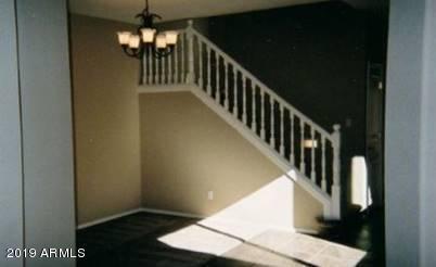 9328 West Berkeley Road Phoenix, AZ 85037 - Photo 8 of 13 a view of staircase with railing and a chandelier