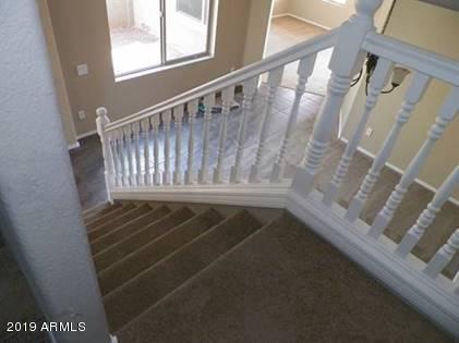 9328 West Berkeley Road Phoenix, AZ 85037 - Photo 10 of 13 a view of staircase with railing and white walls