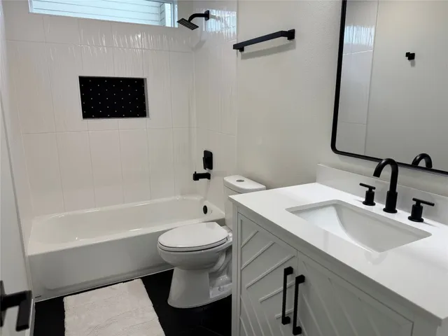 a bathroom with a sink a toilet and bathtub